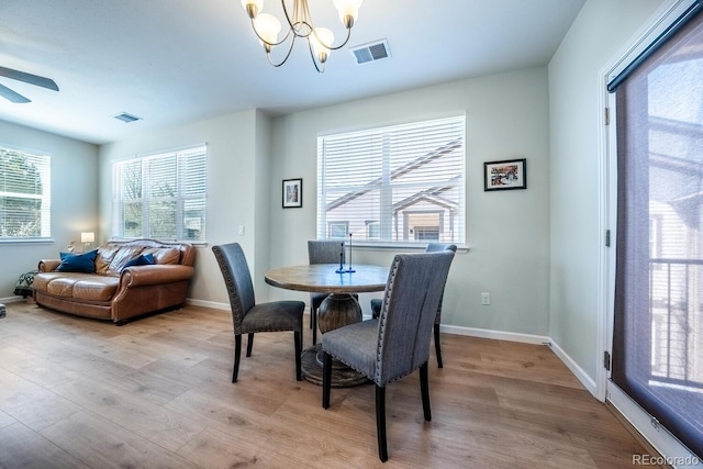 dining area featuring visible vents, light wood-style floors, and a healthy amount of sunlight