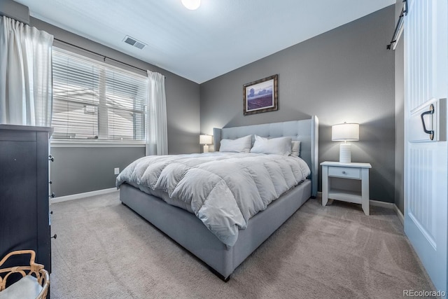 carpeted bedroom with visible vents and baseboards