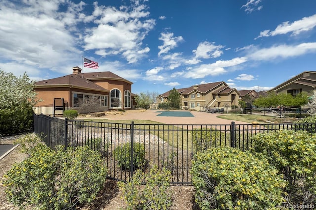 exterior space with a patio, fence private yard, a residential view, and stucco siding