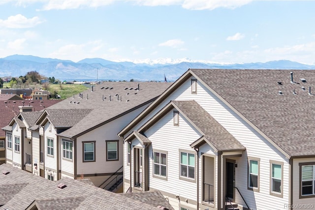 view of front facade with a shingled roof and a mountain view