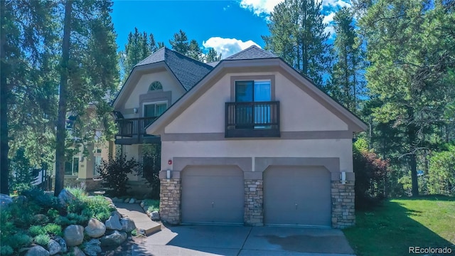 view of front of property with a balcony and a garage