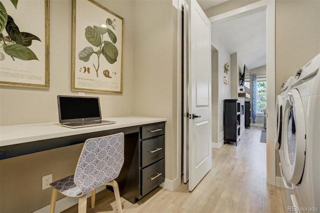 home office featuring light wood-style flooring, separate washer and dryer, built in desk, and baseboards