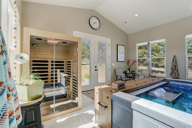 interior space with a sauna, french doors, and vaulted ceiling