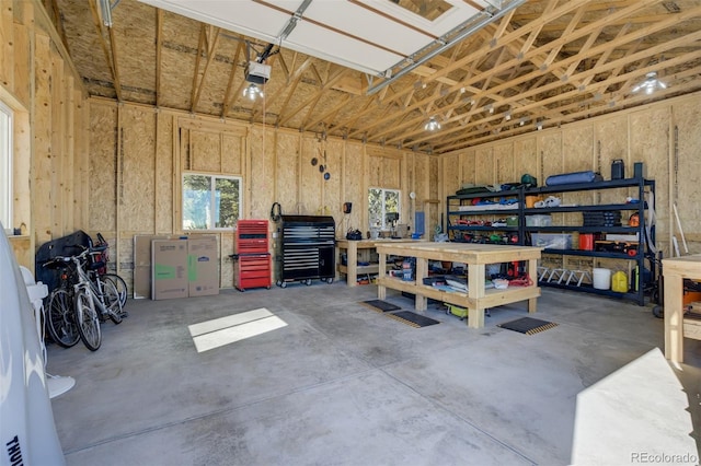 garage with a workshop area and a garage door opener