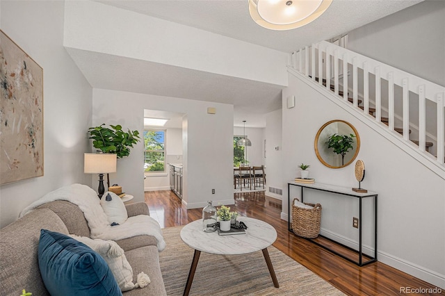 5210 Garrison St Unit 2, Arvada, CO 80002 - living room with wood finished floors, stairs, and a textured ceiling