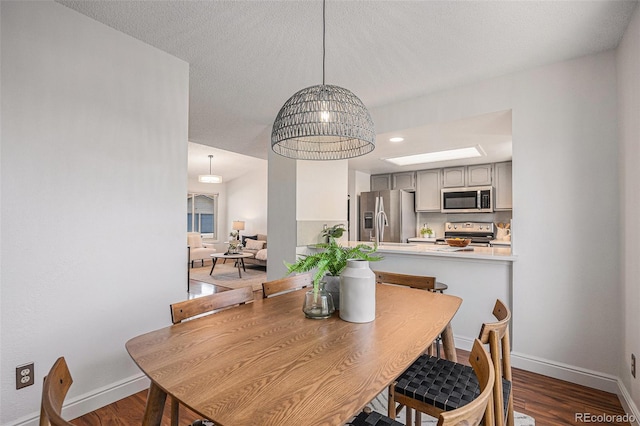 5210 Garrison St Unit 2, Arvada, CO 80002 - dining area with baseboards and dark wood-style floors