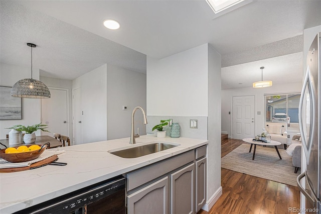 5210 Garrison St Unit 2, Arvada, CO 80002 - kitchen with black dishwasher, dark wood finished floors, freestanding refrigerator, gray cabinetry, and light stone counters