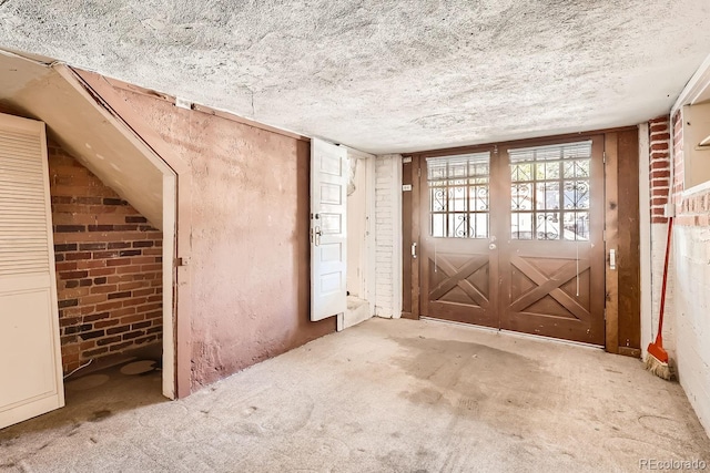 misc room with lofted ceiling and a textured ceiling