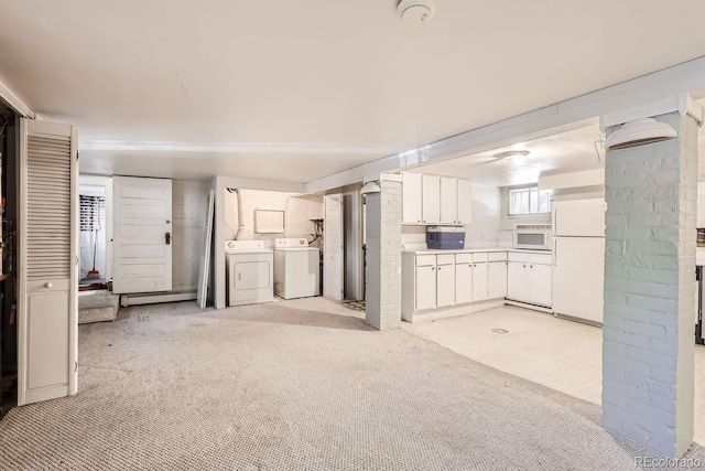 unfurnished living room featuring baseboard heating, light carpet, and independent washer and dryer