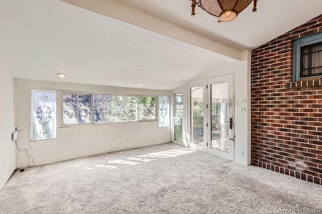 unfurnished sunroom featuring vaulted ceiling