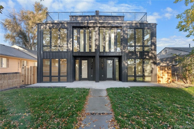 exterior space featuring a lawn and a balcony