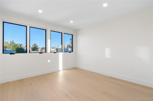 unfurnished room with light wood-type flooring