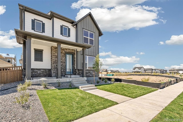 21022 E 63rd Dr, Aurora, CO 80019 - view of front of home with covered porch and a front lawn