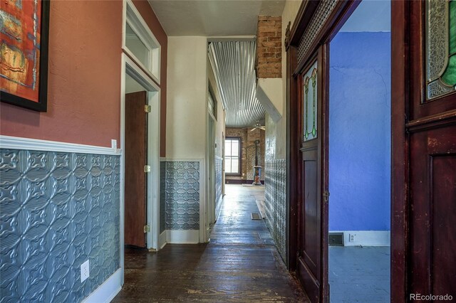 hallway with hardwood / wood-style flooring