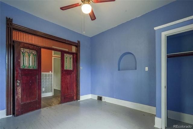 unfurnished bedroom featuring a closet, ceiling fan, and dark hardwood / wood-style flooring