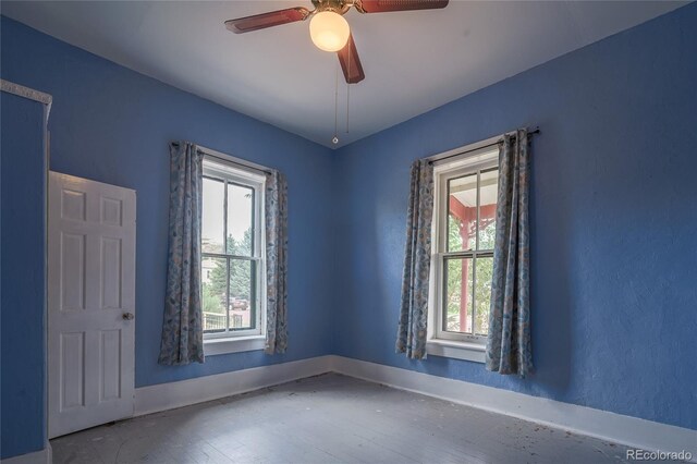 unfurnished room with ceiling fan and plenty of natural light