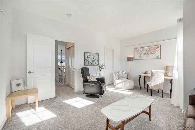 sitting room featuring light carpet