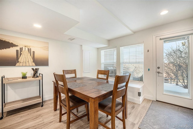 dining area with light hardwood / wood-style floors and plenty of natural light