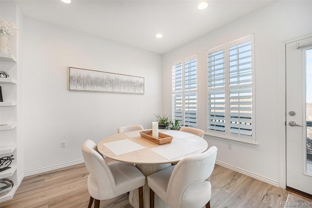 dining space with light hardwood / wood-style floors