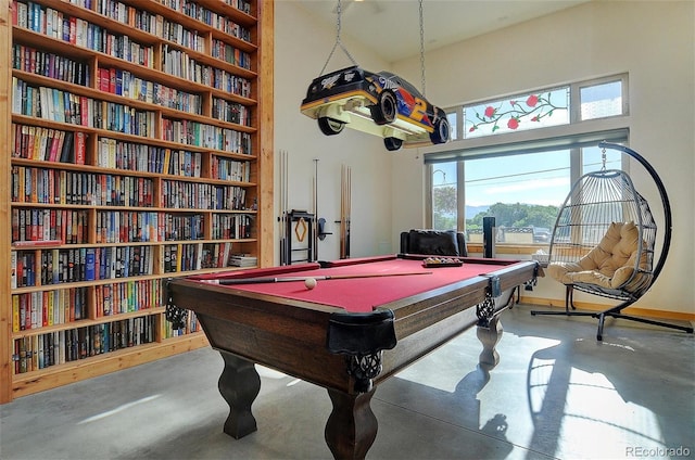 rec room with billiards, concrete flooring, and a healthy amount of sunlight