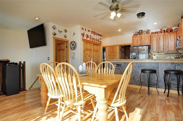 dining space featuring light hardwood / wood-style flooring and ceiling fan