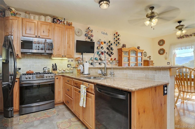 kitchen with black appliances, light stone counters, kitchen peninsula, and ceiling fan