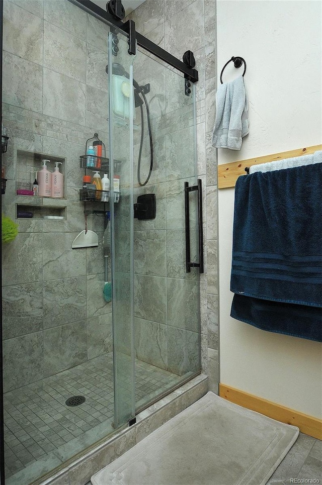 bathroom featuring a shower with door