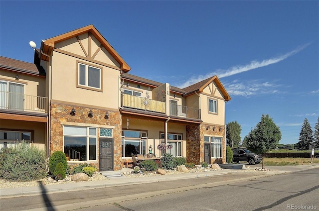123 Halleys Ave Unit C, Poncha Springs, CO 81242 - view of front facade featuring stone siding, a balcony, and stucco siding