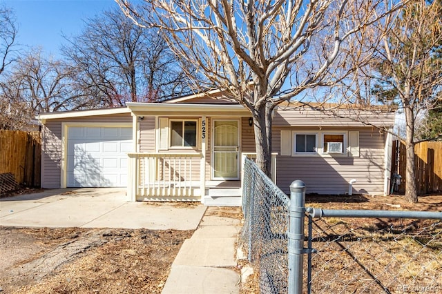 single story home featuring driveway, a garage, fence, and a porch