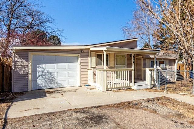 view of front of property with driveway, an attached garage, fence, and a porch