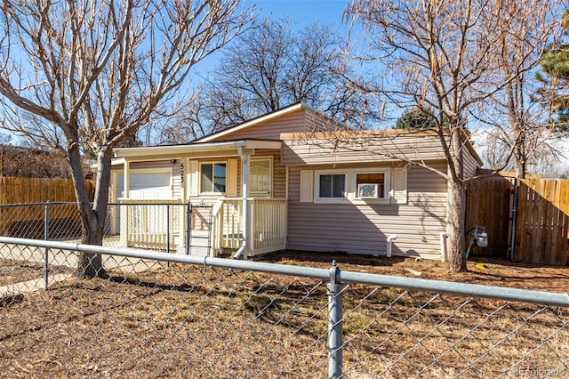 bungalow-style house with a fenced front yard and a porch