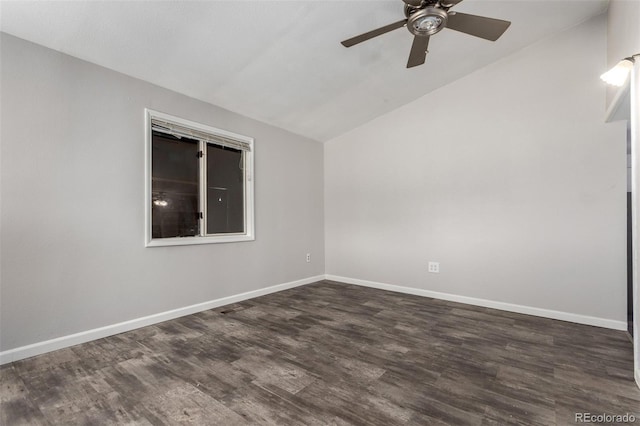 spare room with a ceiling fan, dark wood-style flooring, vaulted ceiling, and baseboards