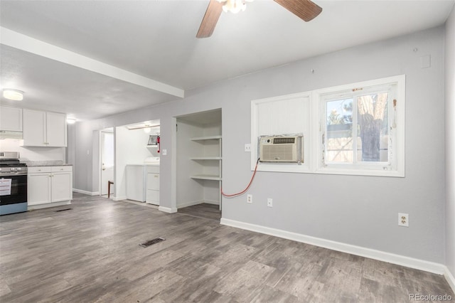 kitchen with gas stove, white cabinets, visible vents, and wood finished floors