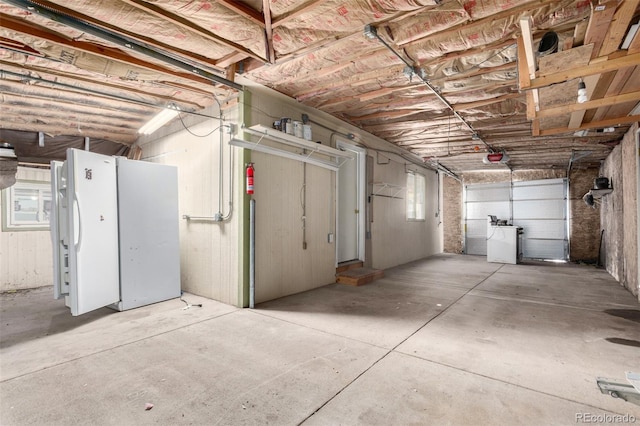 garage featuring a garage door opener and washer / dryer