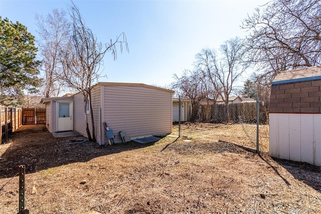 exterior space featuring a fenced backyard and an outdoor structure