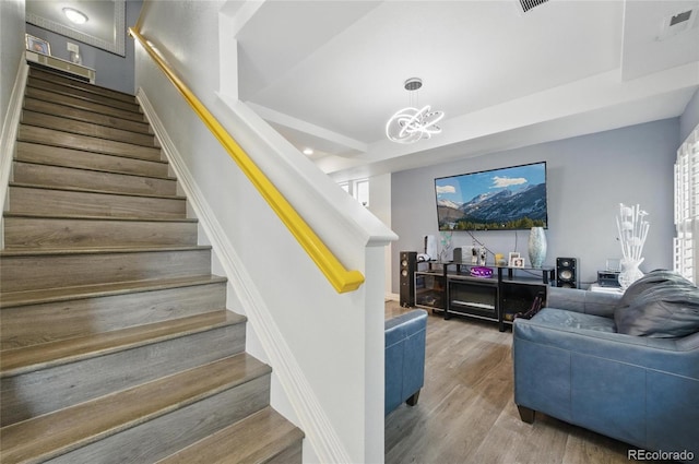 18619 E 50th Pl, Denver, CO 80249 - staircase featuring wood finished floors and a chandelier
