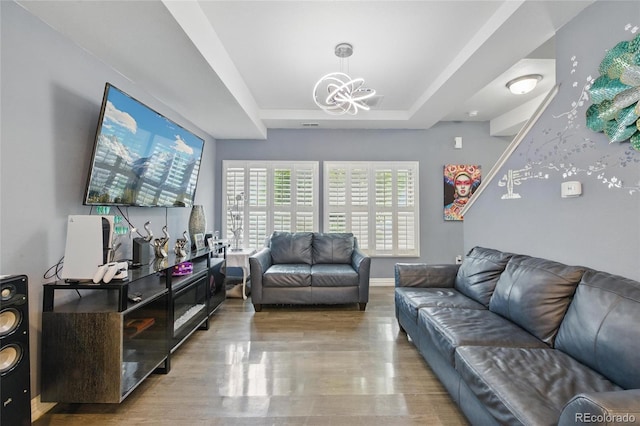 18619 E 50th Pl, Denver, CO 80249 - living area with a chandelier, a tray ceiling, wood finished floors, and baseboards