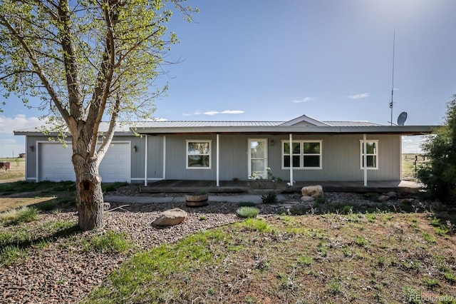 39045 Big Springs Rd, Rush, CO 80833 - ranch-style house with a porch, a garage, and metal roof