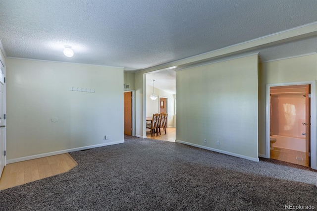 39045 Big Springs Rd, Rush, CO 80833 - carpeted empty room with a textured ceiling, ornamental molding, and baseboards