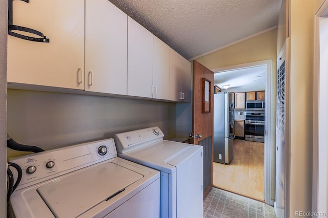 39045 Big Springs Rd, Rush, CO 80833 - laundry area featuring cabinet space, independent washer and dryer, and a textured ceiling