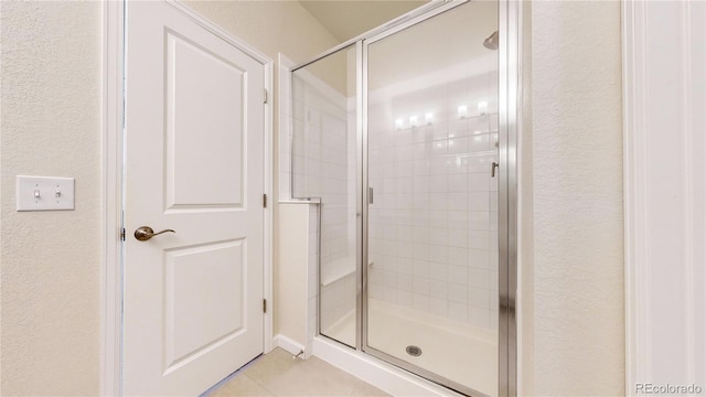 bathroom featuring tile patterned floors and an enclosed shower