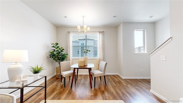 dining room with a chandelier and wood-type flooring