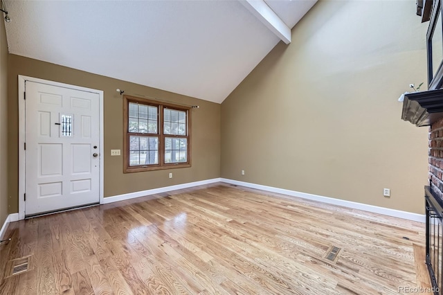 entrance foyer featuring beam ceiling, visible vents, light wood-style flooring, and baseboards