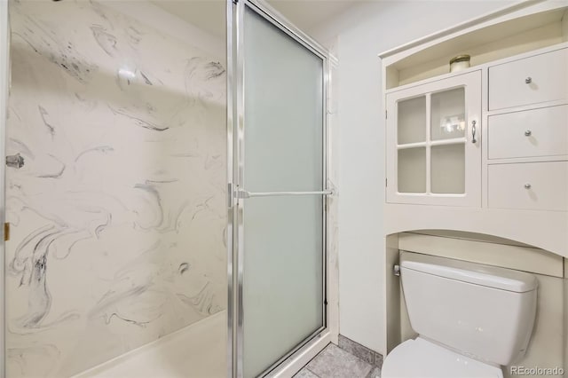 bathroom featuring a shower stall and toilet