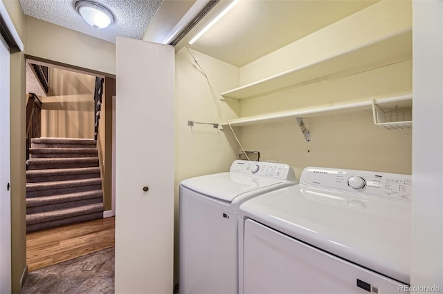 laundry area featuring a textured ceiling, laundry area, and independent washer and dryer