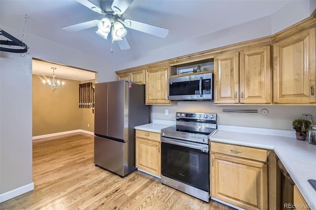 7721 S Curtice Way Unit B, Littleton, CO 80120 - kitchen with appliances with stainless steel finishes, a ceiling fan, light countertops, a chandelier, and light wood-style flooring