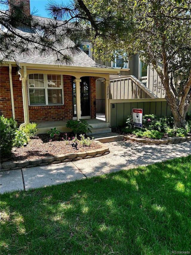 7721 S Curtice Way Unit B, Littleton, CO 80120 - view of front of property with brick siding, a chimney, and a shingled roof