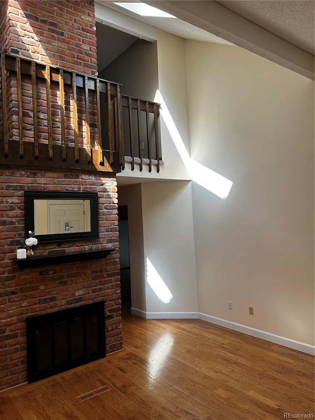 7721 S Curtice Way Unit B, Littleton, CO 80120 - unfurnished living room featuring wood finished floors and lofted ceiling