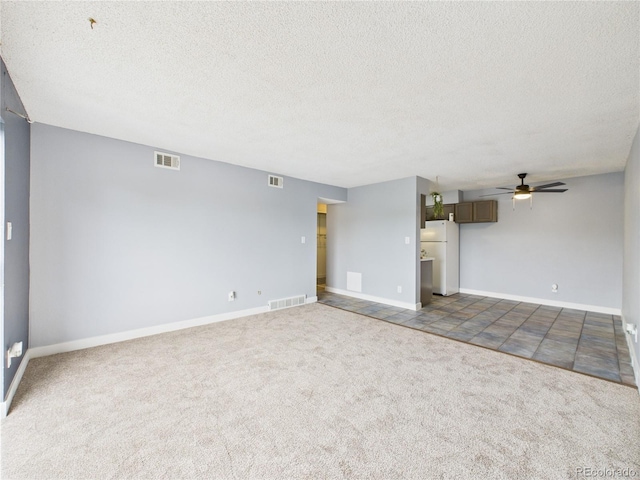 190 E Highline Cir Unit 302, Centennial, CO 80122 - unfurnished living room featuring a textured ceiling, a ceiling fan, carpet floors, and baseboards