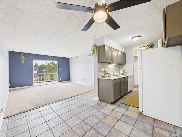 190 E Highline Cir Unit 302, Centennial, CO 80122 - kitchen featuring freestanding refrigerator, light colored carpet, a sink, a textured ceiling, and light countertops